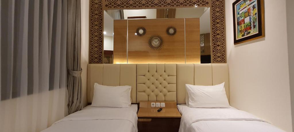 Postel nebo postele na pokoji v ubytování Hotel Daily Inn Bandung