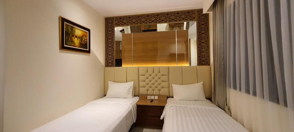 Postel nebo postele na pokoji v ubytování Hotel Daily Inn Bandung