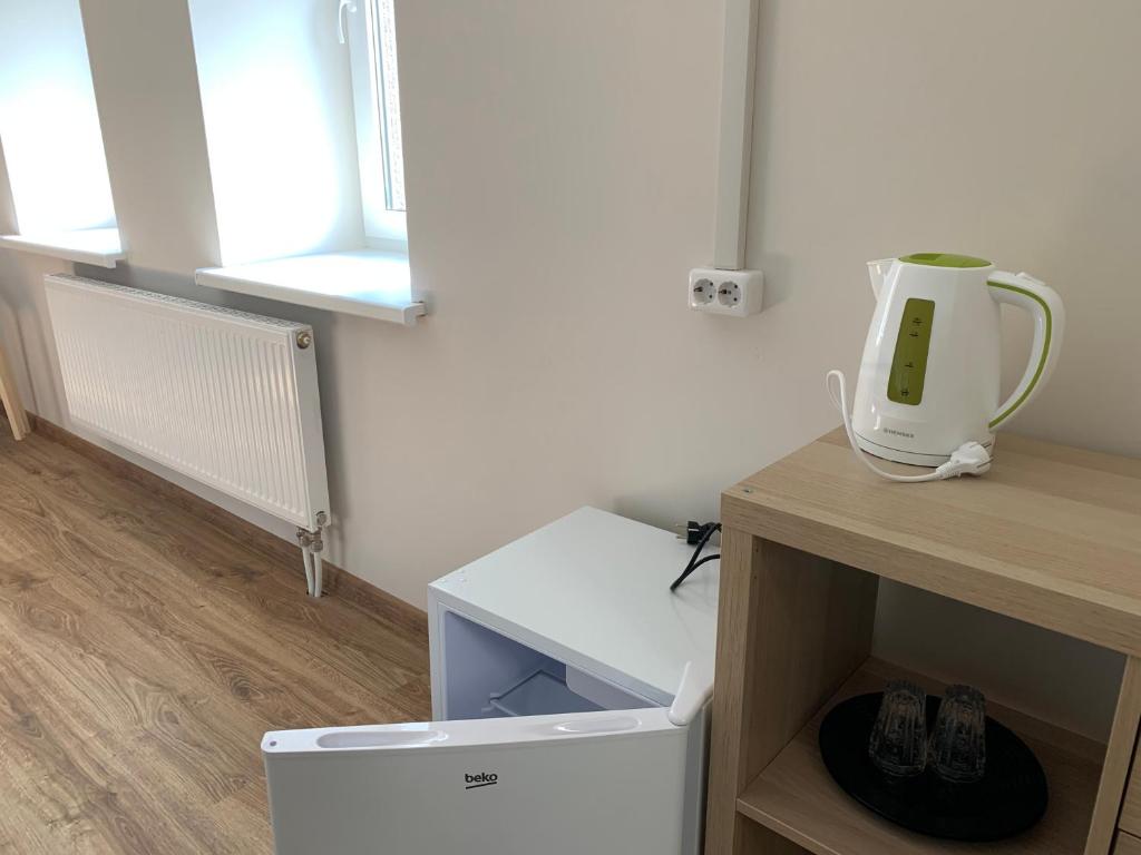 a room with a white appliance sitting on a table at Žvejo krantas Palūšė in Palūšė