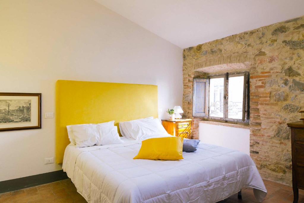 Uma cama ou camas num quarto em Angolo Divino Tuscany