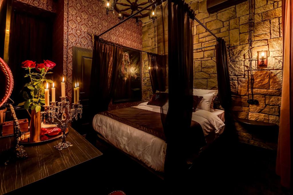 a bedroom with a bed and a stone wall at Mysterio Hotel in Saint Petersburg