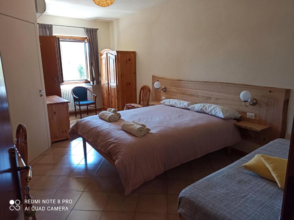 Postel nebo postele na pokoji v ubytování Trattoria della Posta