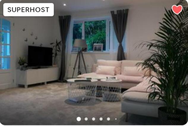 a living room with a couch and a tv at Sunny-side-up in St Austell