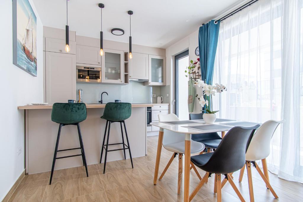 a kitchen and dining room with a table and chairs at Ledeno more Luxury Apartments in Split