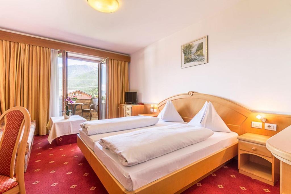 Postel nebo postele na pokoji v ubytování Hotel Montani