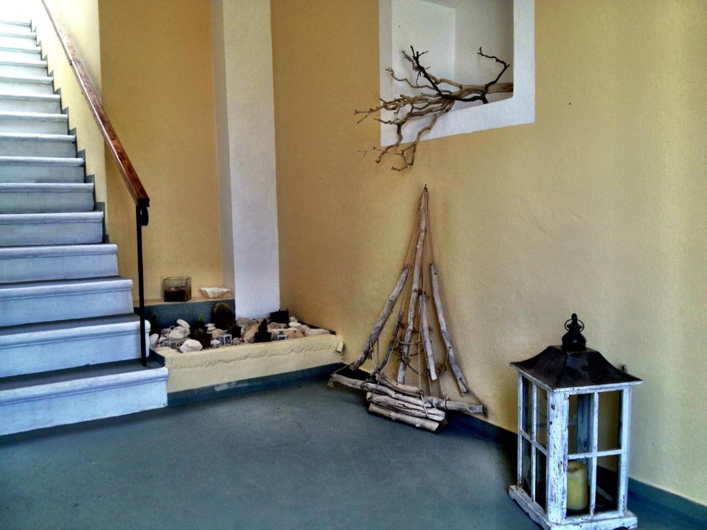 a room with stairs and a boat on the wall at Kiki Studios in Fiskardo