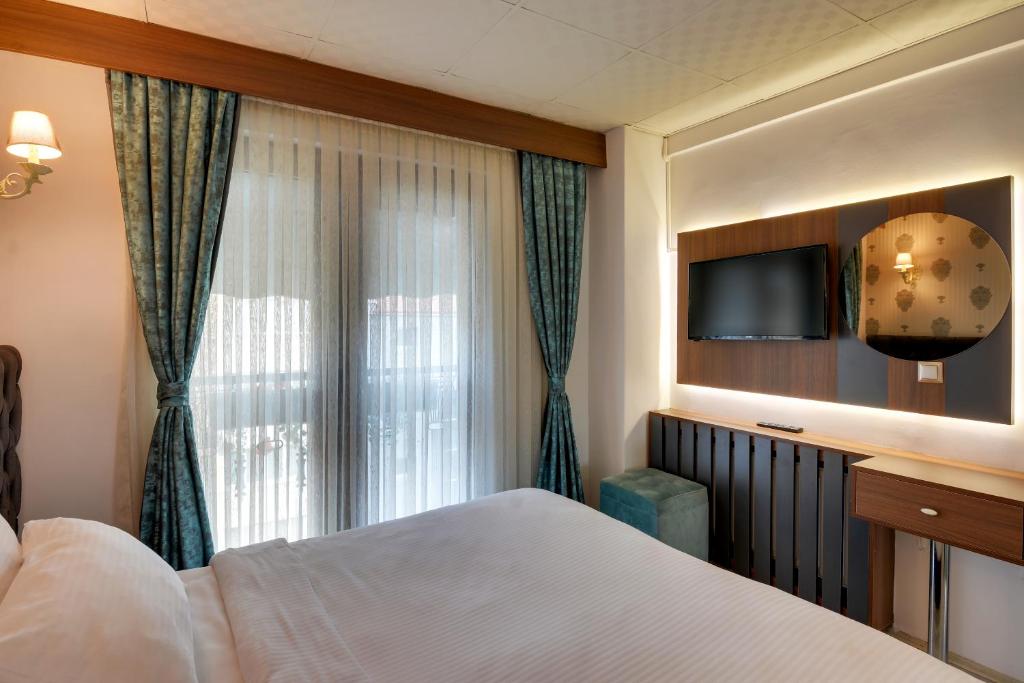 A bed or beds in a room at Grande Stella Hotel