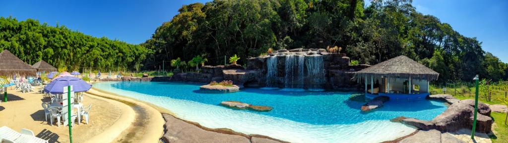 a water park with a waterfall and a water slide at Chalés Praia de Minas in São Lourenço