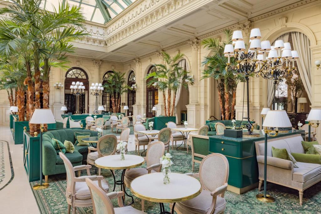 a lobby of a hotel with tables and chairs at InterContinental Paris Le Grand by IHG in Paris