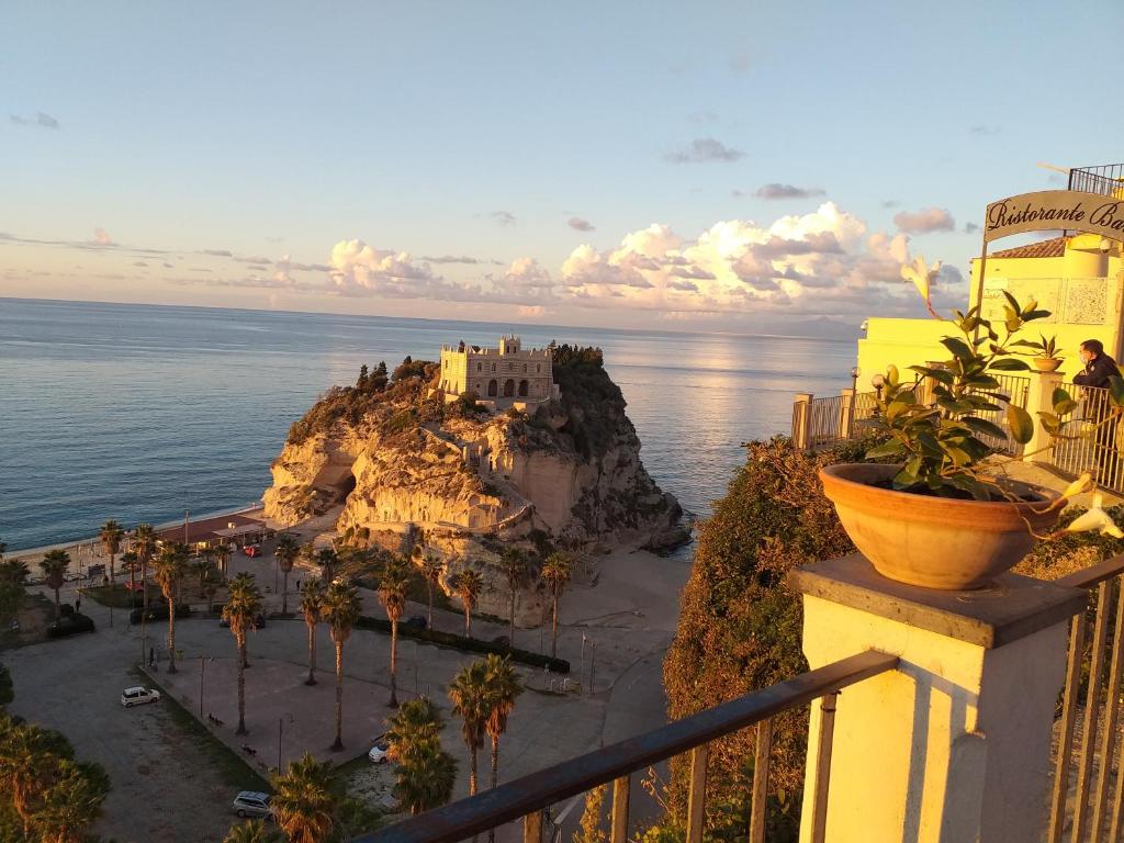 a view of a castle on a cliff next to the ocean at Borgo di Santa Barbara in Santa Domenica