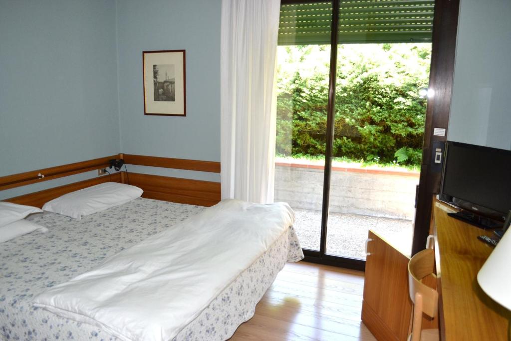 Postel nebo postele na pokoji v ubytování Hotel Canturio