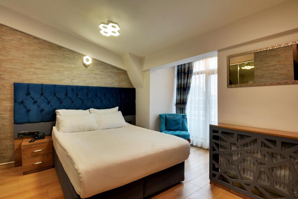 A bed or beds in a room at Grande Stella Hotel