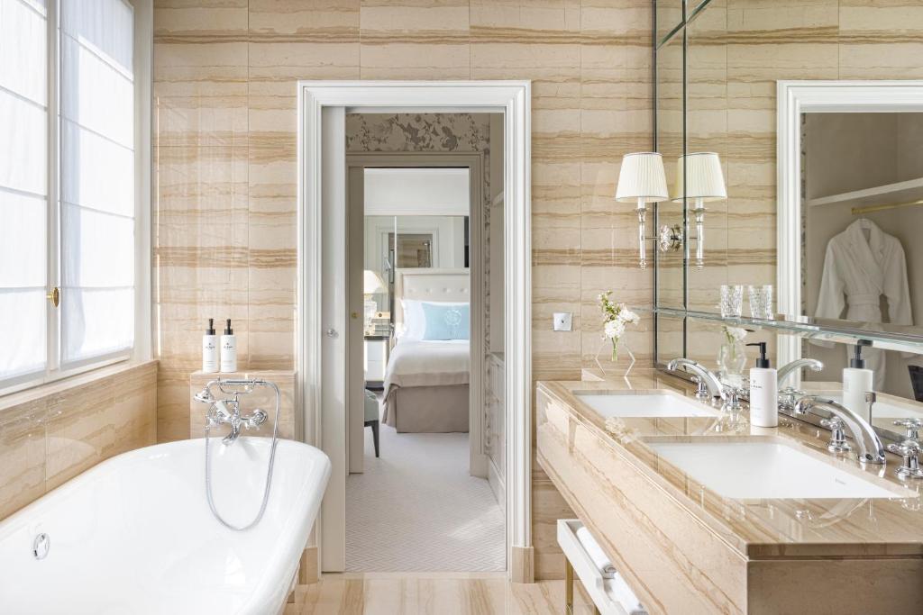 a bathroom with two sinks and a bath tub at InterContinental Paris Le Grand by IHG in Paris