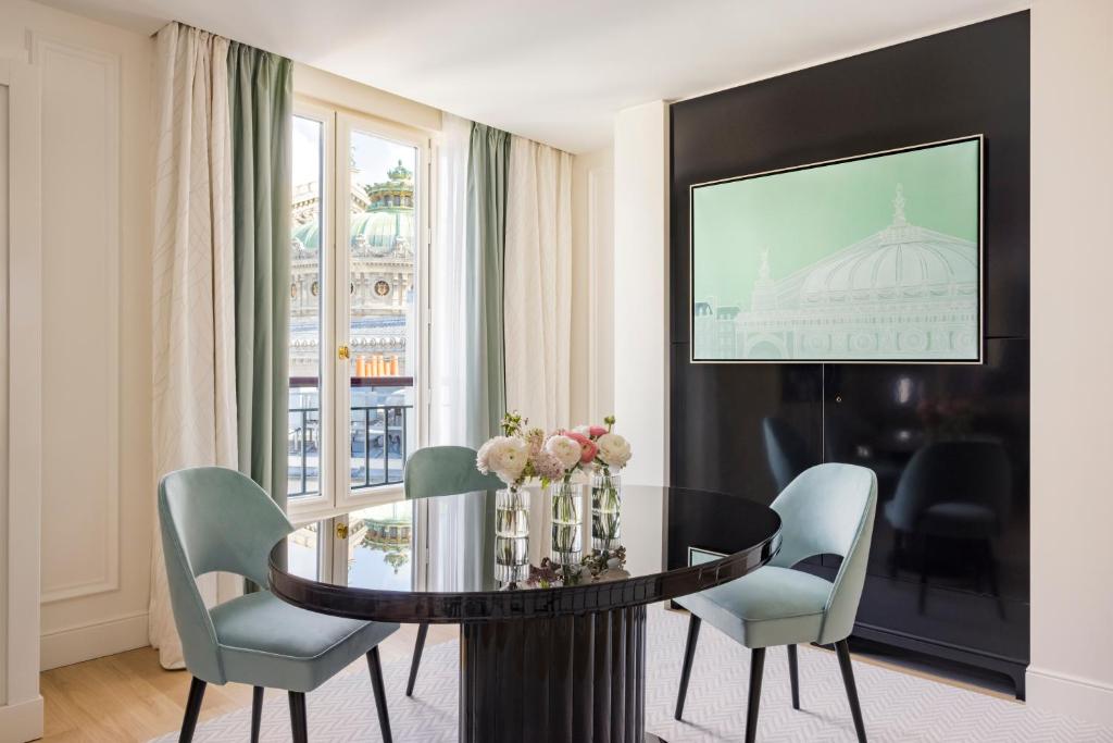 a dining room with a table and chairs and a window at InterContinental Paris Le Grand by IHG in Paris