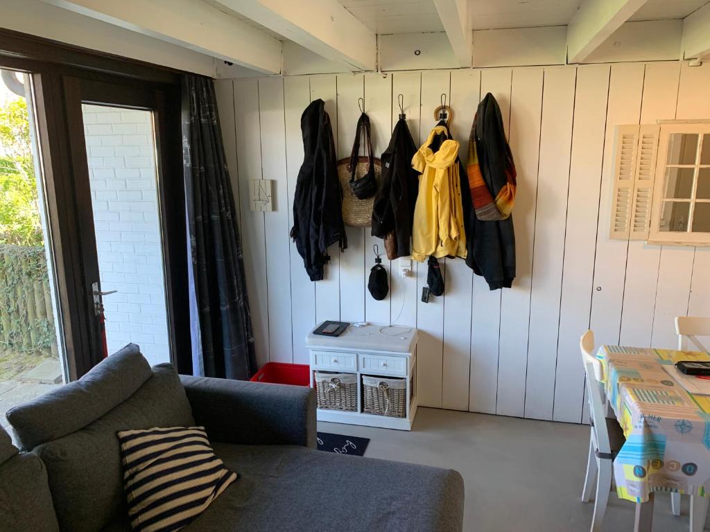 a living room with clothes hanging on the wall at Ysermonde Fisherman's Cottage in Nieuwpoort