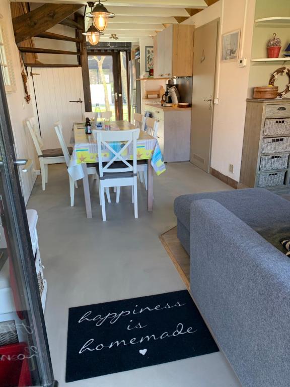 a living room with a couch and a table at Ysermonde Fisherman's Cottage in Nieuwpoort