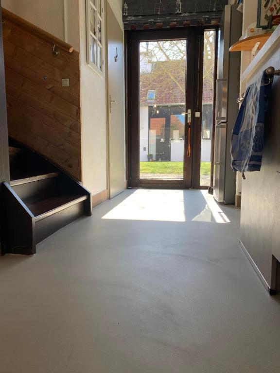 an empty hallway with a door to a building at Ysermonde Fisherman's Cottage in Nieuwpoort