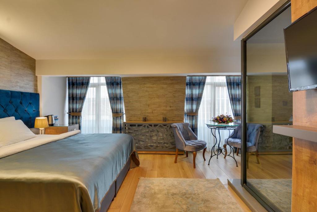 A bed or beds in a room at Grande Stella Hotel