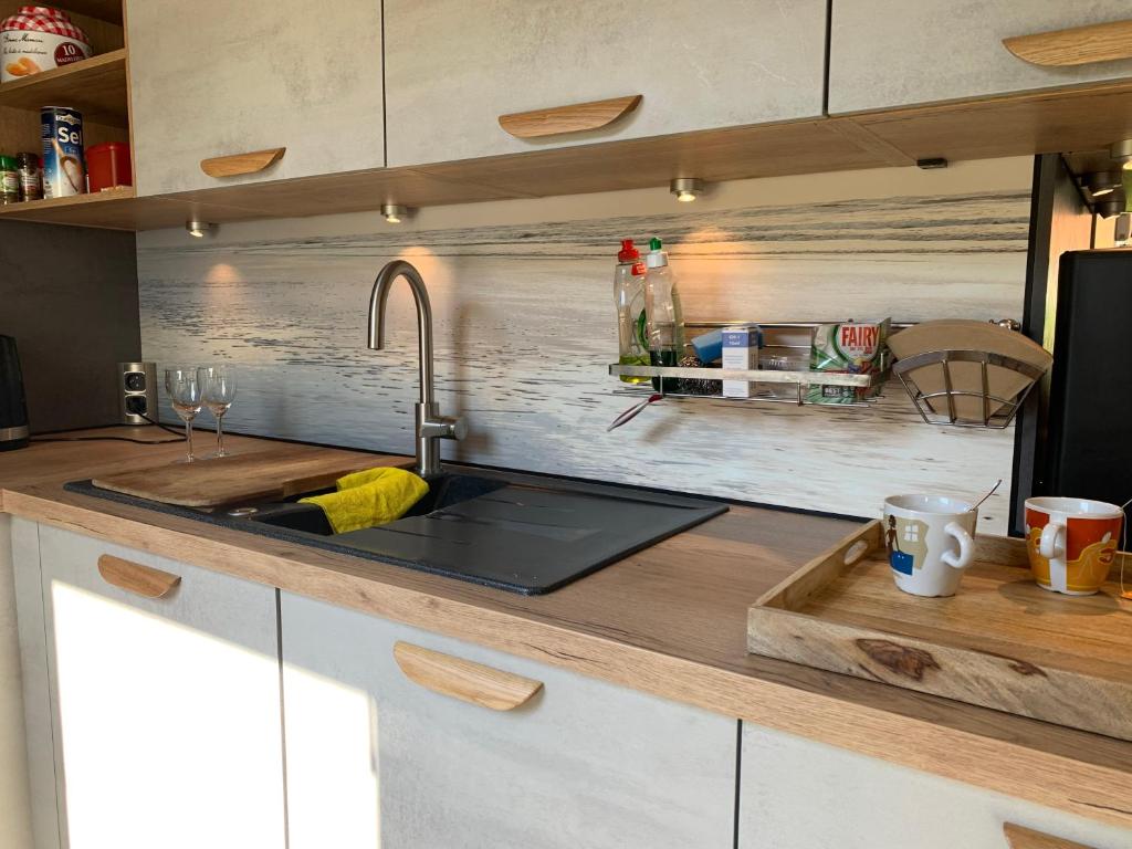 a kitchen with a sink and a counter top at Ysermonde Fisherman's Cottage in Nieuwpoort