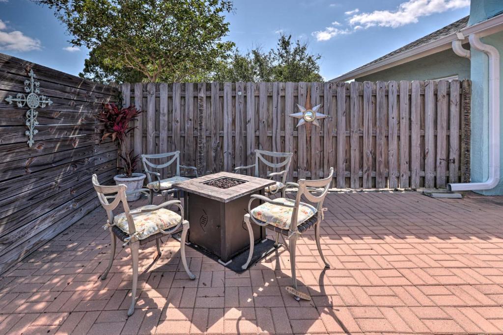 a patio with a table and chairs and a fence at Cape Canaveral Escape with Grill Walk to Beach! in Cape Canaveral
