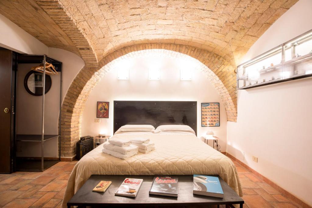 a bedroom with a large bed in a brick wall at Restart Accommodations Balestra in Rome