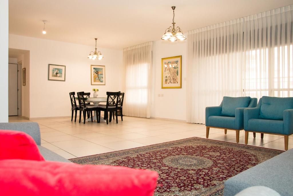 a living room with a table and chairs at Luxurious Huge 5R in Jerusalem center in Jerusalem