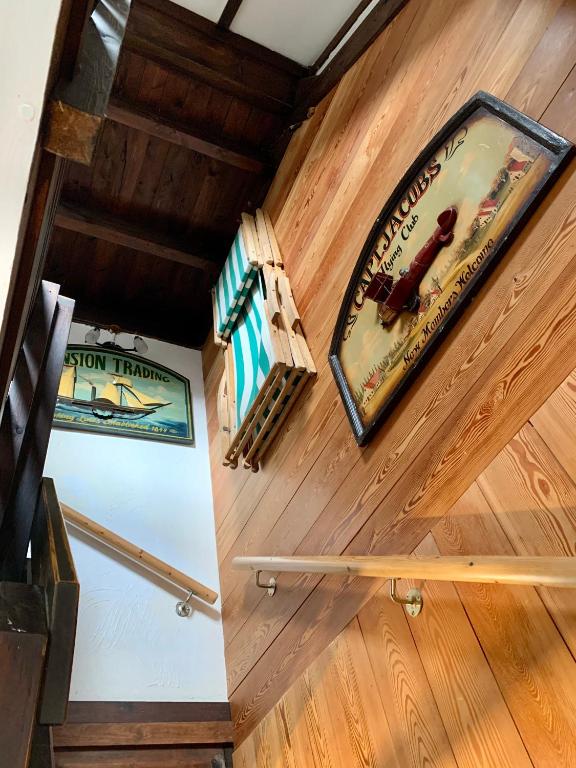a staircase in a room with wooden walls and wooden floors at Ysermonde Fisherman's Cottage in Nieuwpoort