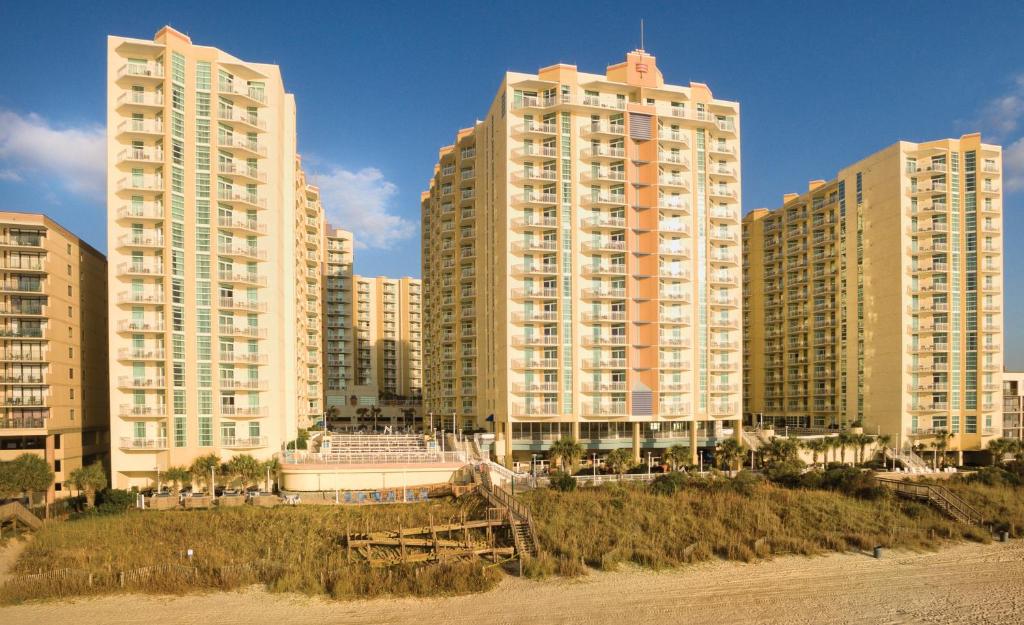 a group of tall buildings next to the beach at Club Wyndham Ocean Boulevard in Myrtle Beach