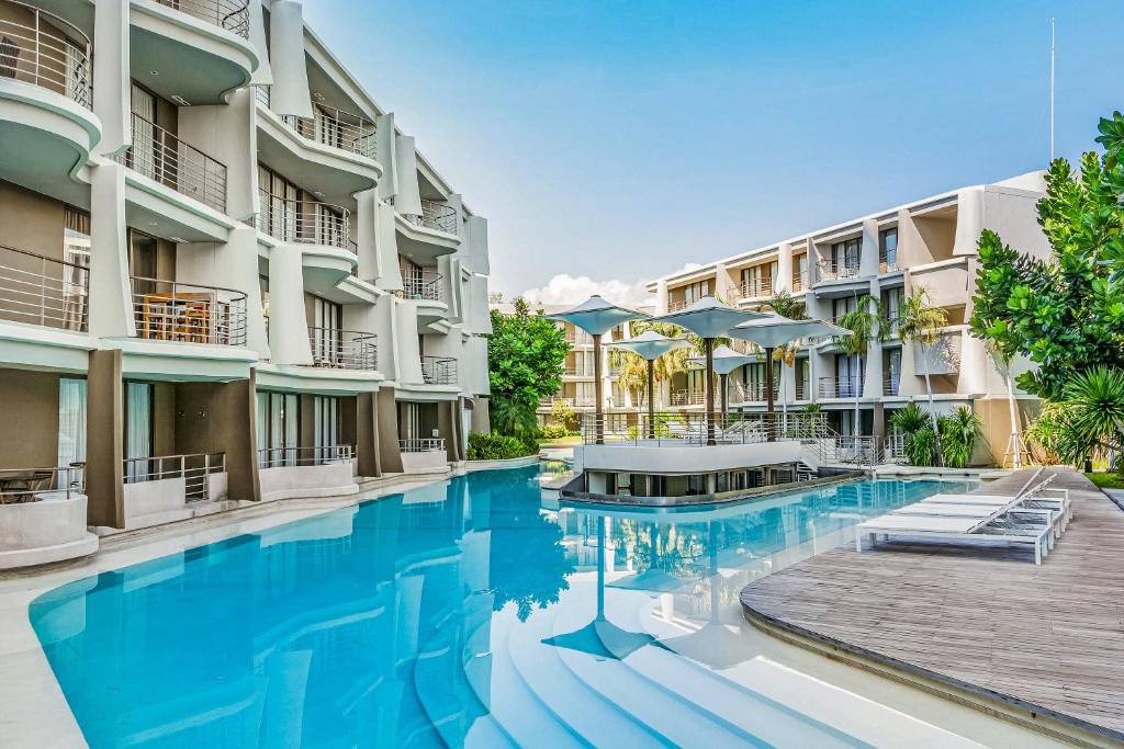 a swimming pool in front of some apartment buildings at Baan San Kraam Cha Am-Hua Hin by Favstay in Cha Am