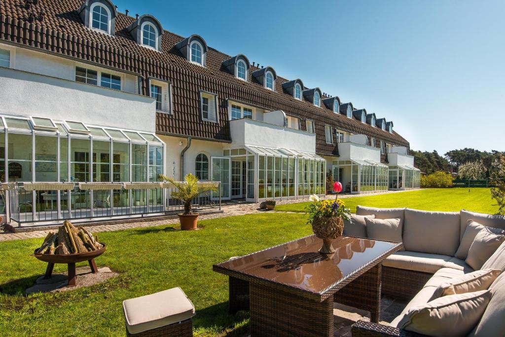 a courtyard of a building with a couch and a table at Ostseeresidenz Apartments in Rerik