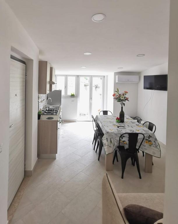 a kitchen and dining room with a table and chairs at Emidio House in Termini