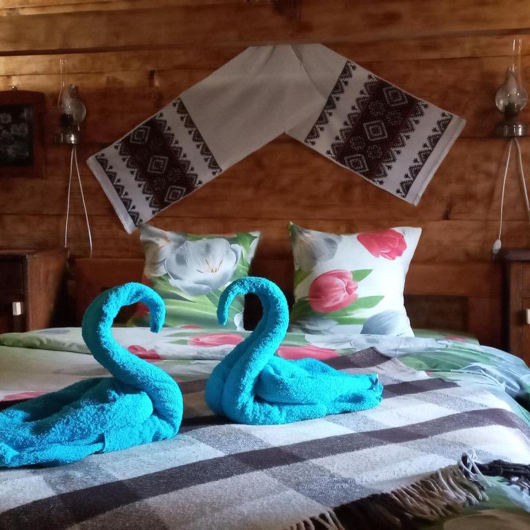 Postel nebo postele na pokoji v ubytování Гуцульська Спадщина