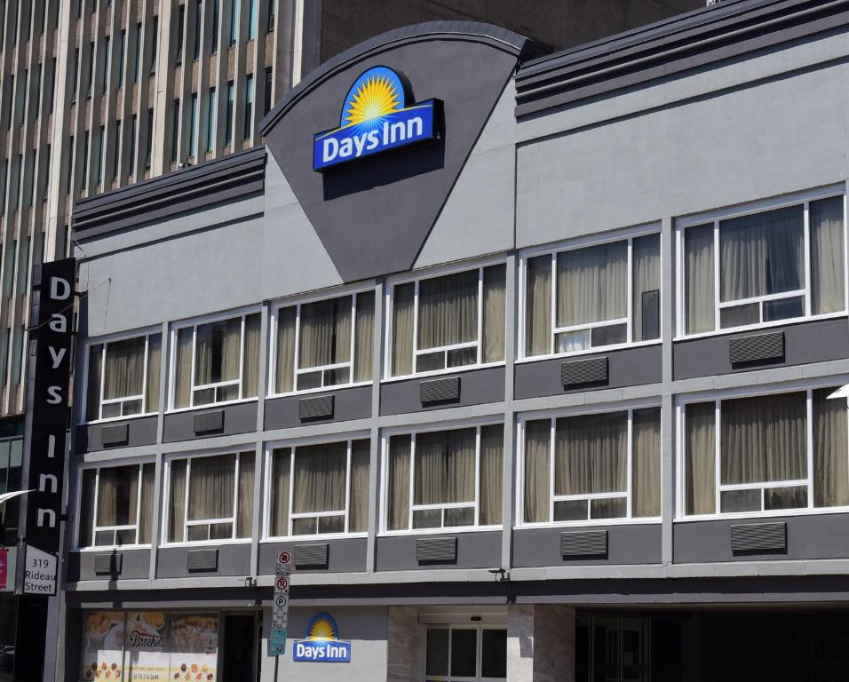 a building with a danish firm sign on it at Days Inn by Wyndham Ottawa in Ottawa