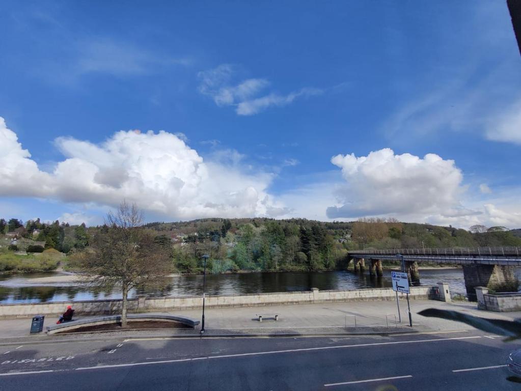 a view of a river with a bridge and a road at Stunning 2 Bedroom River View Apartment in Perth