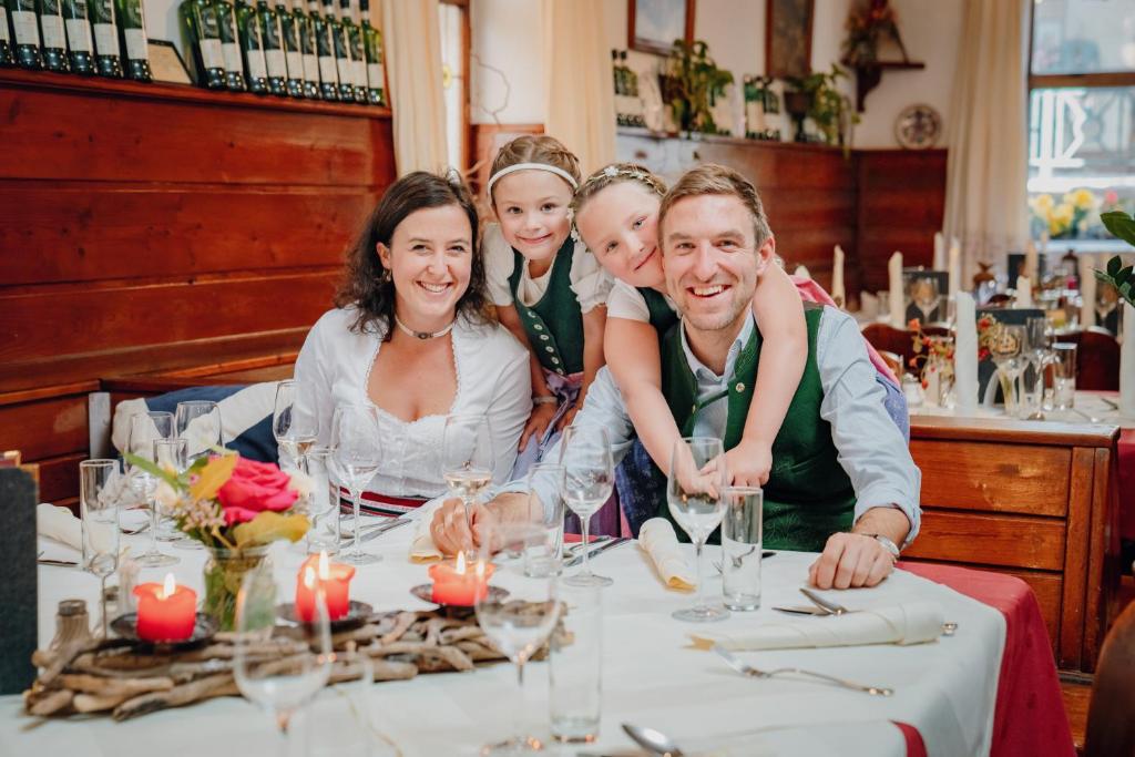 a family sitting at a table in a restaurant at Hotel Drei Hasen in Mariazell