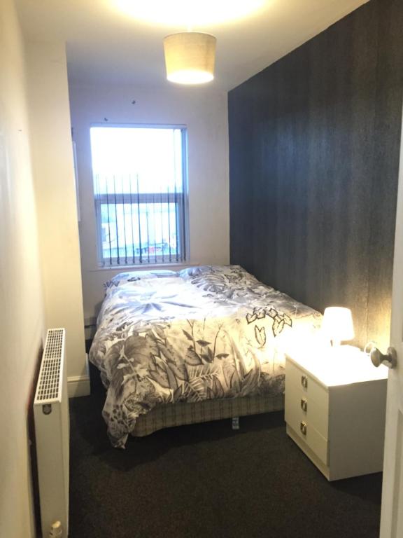 a bedroom with a bed and a window at Private double room near City centre, Coventry in Coventry