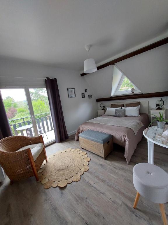 a bedroom with a bed and a large window at Le relais globe trotteur in Montaigu