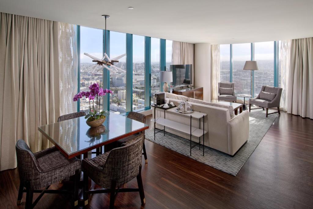 a living room with a couch and a table with chairs at InterContinental San Francisco, an IHG Hotel in San Francisco