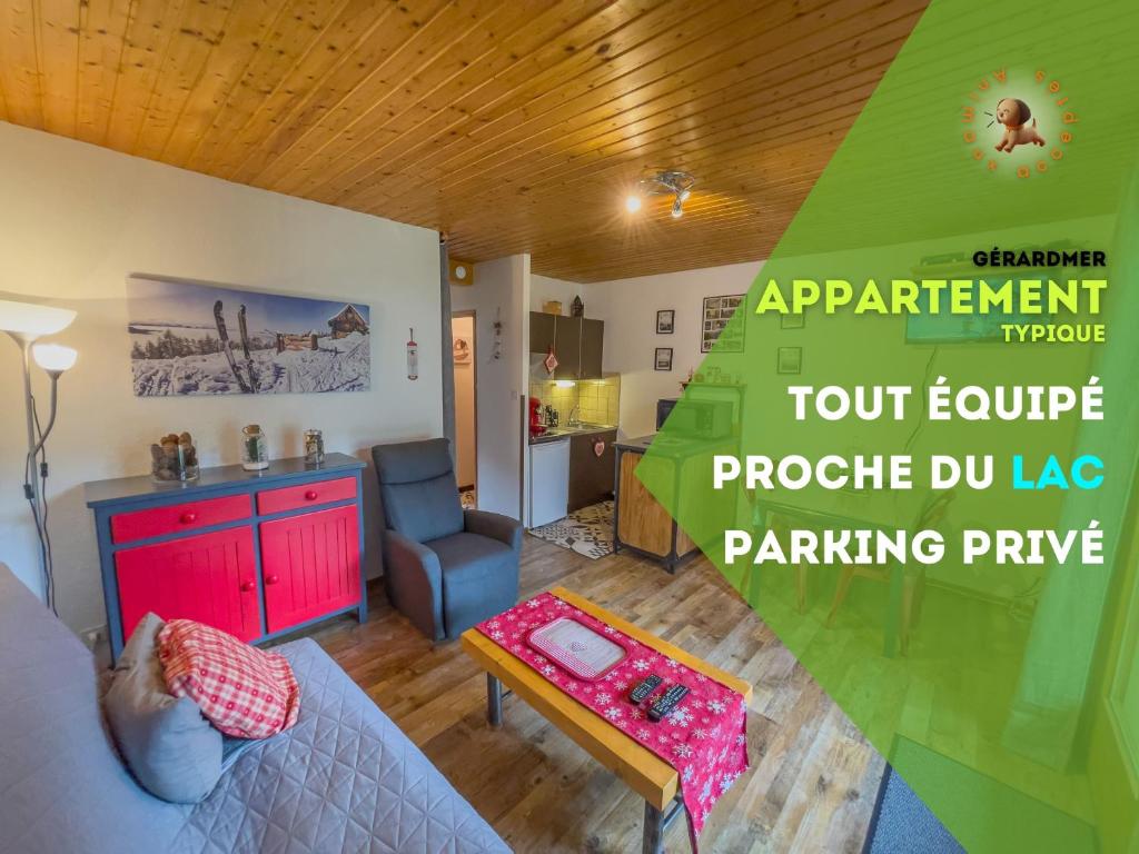 a living room with a room with a table and a couch at Appartement 'Les Airelles du Lac' T2 Gérardmer in Gérardmer