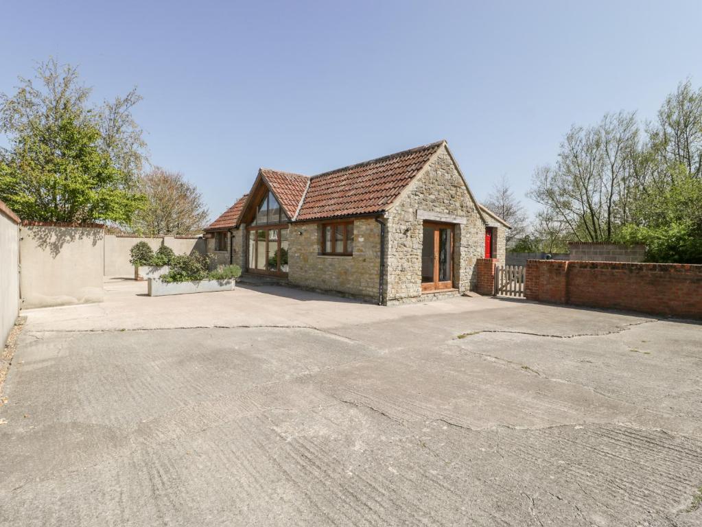 a house with a large driveway in front of it at The Stone Barn in Shepton Mallet