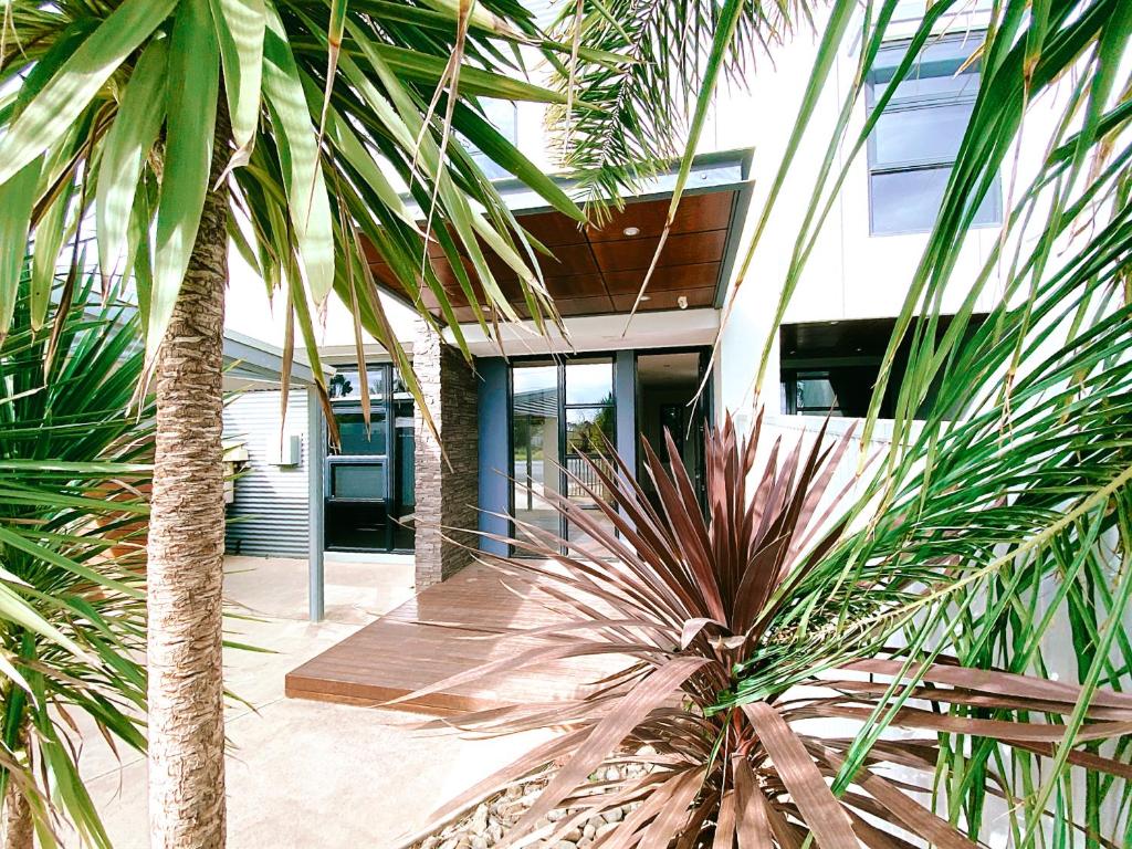 a building with palm trees in front of it at RL Apartments in Moama