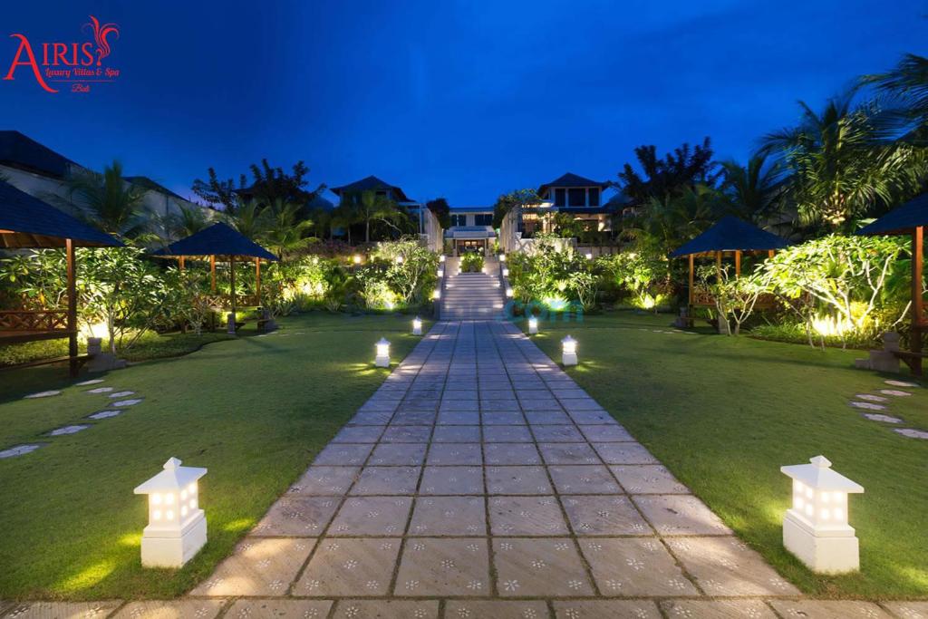 a pathway leading to a resort at night with lights at Airis Luxury Villas and Spa in Uluwatu