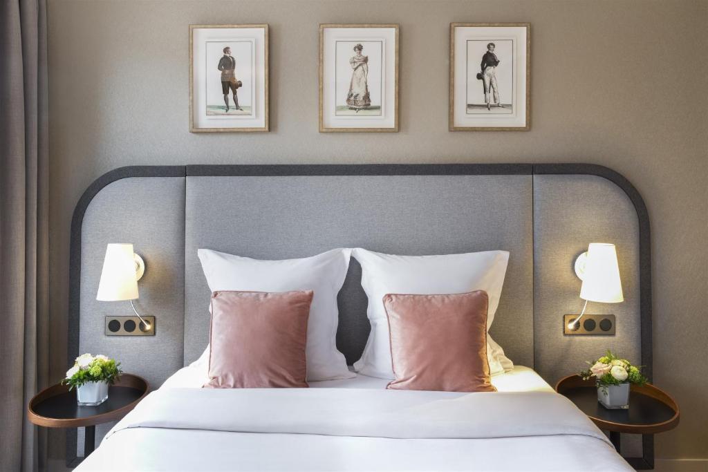 a bedroom with a bed and two tables with pillows at Warwick Reine Astrid - Lyon in Lyon