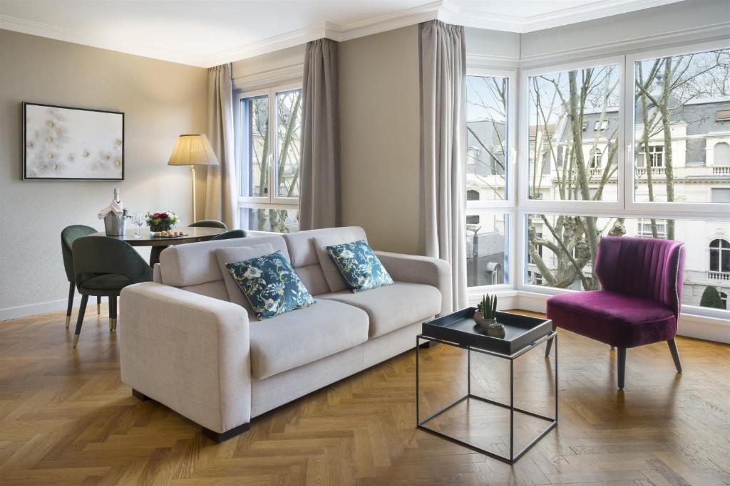 a living room with a couch and a table at Warwick Reine Astrid - Lyon in Lyon