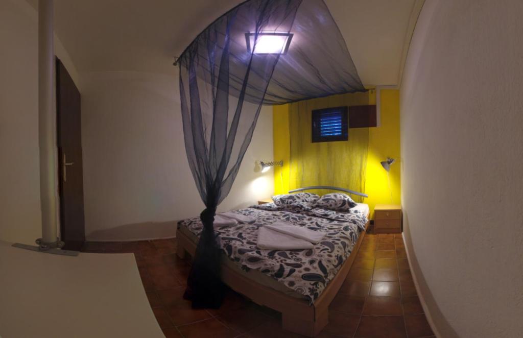 a bedroom with a bed with a canopy at The Sea House Apartments in Vis