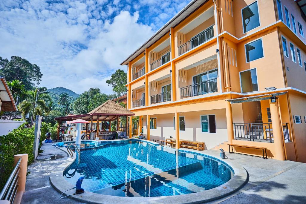an image of a swimming pool in front of a building at Budchui Village2 in Koh Tao