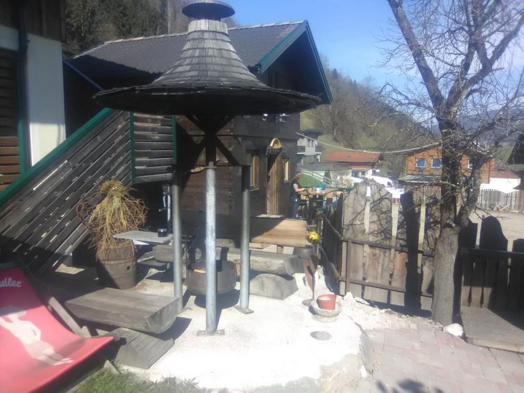 a small house with a bird feeder in the yard at Troadkasten Seinerzeit in Aich