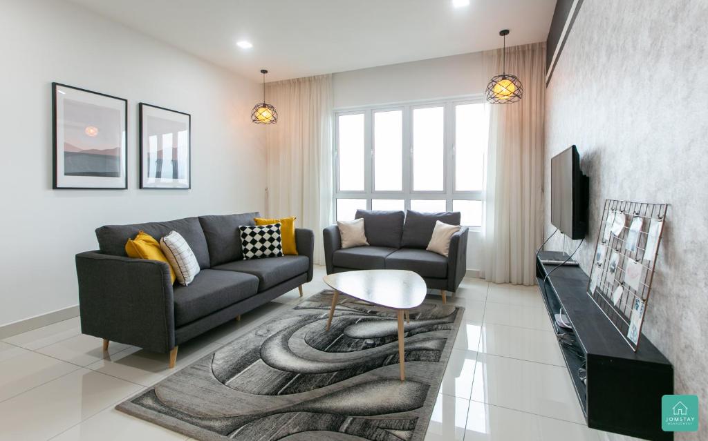a living room with a couch and a table at Jomstay Octagon Duplex Penthouse Ipoh Town in Ipoh