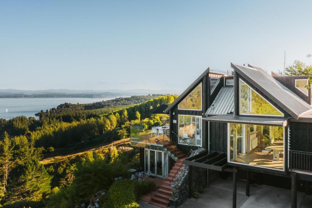 an image of a house with a view of the water at Acacia Cliffs Lodge in Taupo