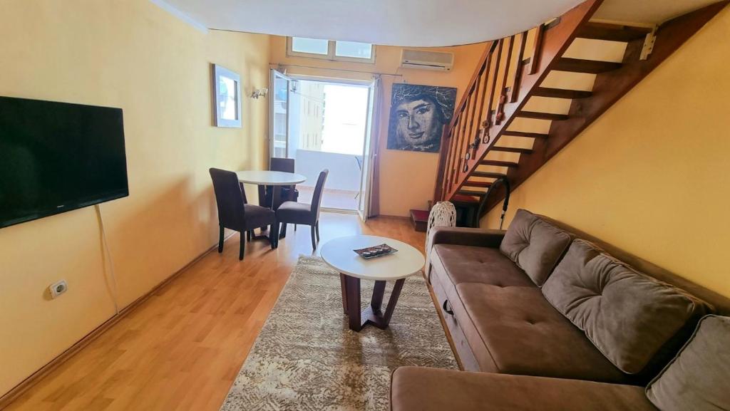 a living room with a couch and a table at Becici Apart Budva in Budva